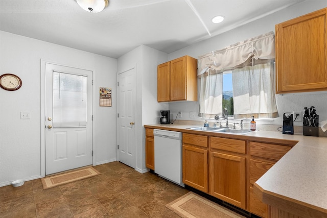 kitchen with plenty of natural light, white dishwasher, a sink, and light countertops