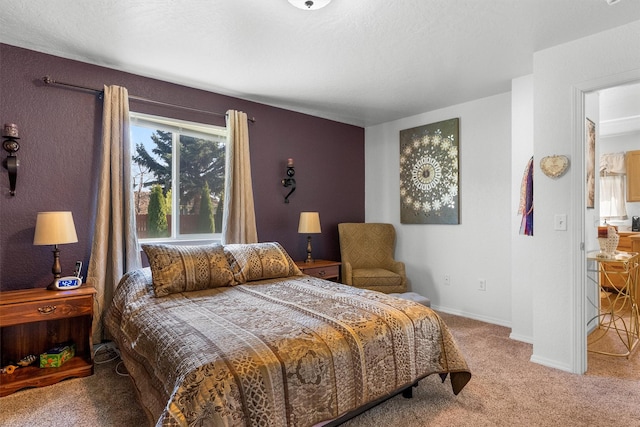 carpeted bedroom featuring baseboards