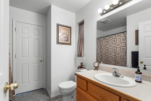 bathroom featuring vanity, a shower with curtain, toilet, and visible vents