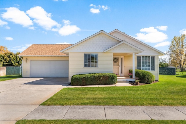 view of front of house featuring concrete driveway, an attached garage, fence, and a front lawn