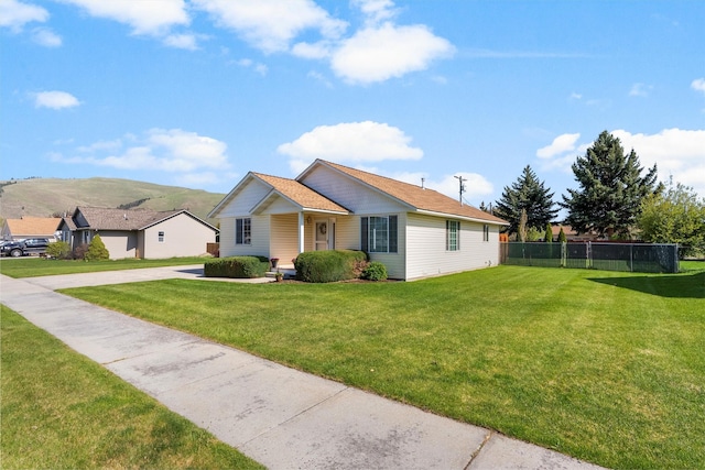 view of front of home with a front lawn, fence, and concrete driveway