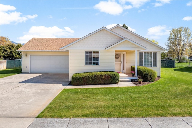 view of front of property featuring a garage, fence, concrete driveway, and a front yard