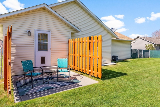 back of property featuring a lawn, a patio area, fence, cooling unit, and a shingled roof