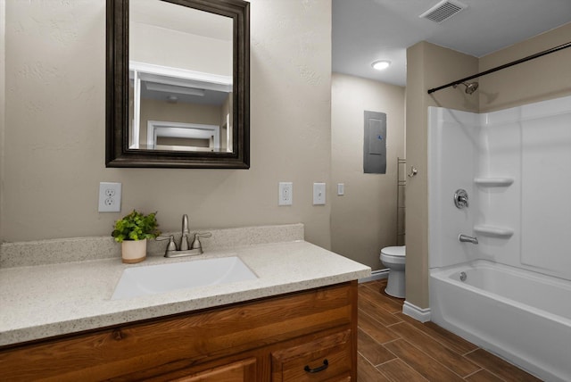 full bath featuring vanity, toilet, shower / washtub combination, wood tiled floor, and visible vents