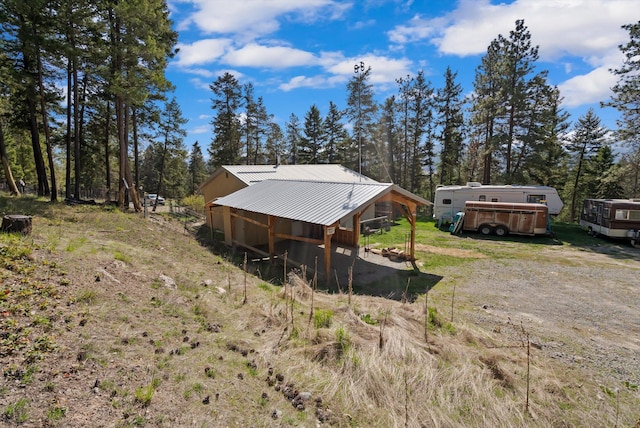 rear view of house with an outbuilding and metal roof