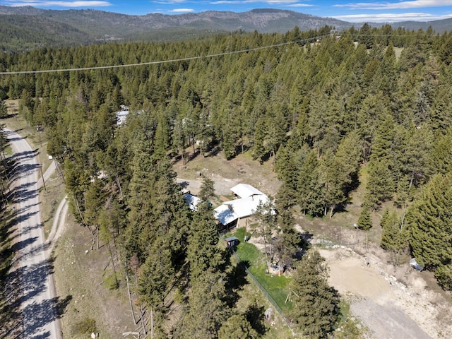 birds eye view of property with a view of trees and a mountain view