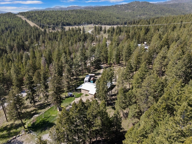 drone / aerial view with a mountain view and a forest view
