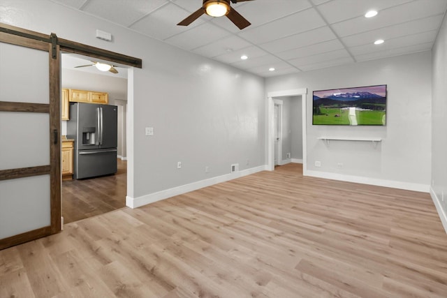unfurnished living room with light wood-style floors, baseboards, ceiling fan, and recessed lighting