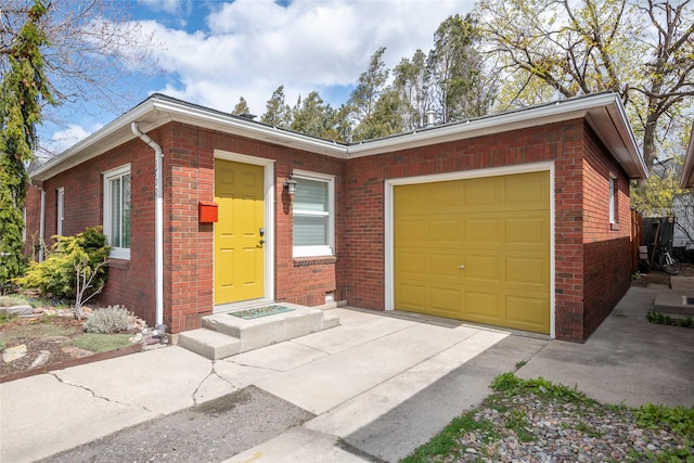 1702 Bancroft St, Missoula, MT 59801 - ranch-style home featuring a garage, concrete driveway, and brick siding