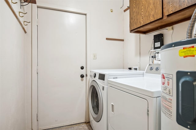 1702 Bancroft St, Missoula, MT 59801 - laundry area featuring washer and dryer, cabinet space, and electric water heater