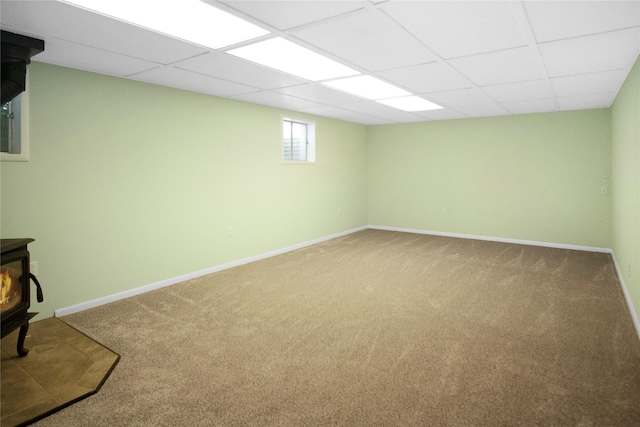 330 Bowman Rd, Hamilton, MT 59840 - basement with carpet, a wood stove, and a paneled ceiling
