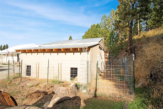 330 Bowman Rd, Hamilton, MT 59840 - view of home's exterior with concrete block siding, an outbuilding, and a metal roof