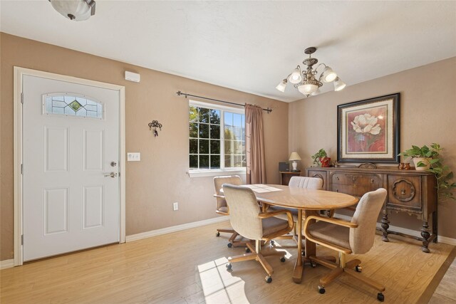 1020 3rd Ave E, Columbia Falls, MT 59912 - dining room featuring baseboards, a notable chandelier, and light wood-style floors