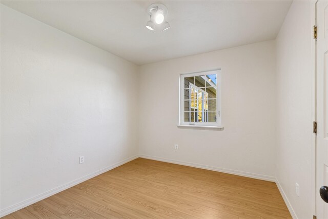 1020 3rd Ave E, Columbia Falls, MT 59912 - empty room with baseboards and light wood-style flooring