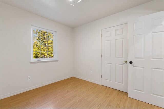 1020 3rd Ave E, Columbia Falls, MT 59912 - unfurnished room with baseboards and light wood finished floors