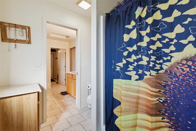 1020 3rd Ave E, Columbia Falls, MT 59912 - bathroom with vanity, tile patterned floors, toilet, and curtained shower