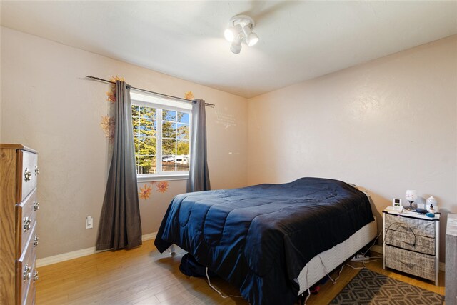 1020 3rd Ave E, Columbia Falls, MT 59912 - bedroom featuring baseboards, a ceiling fan, and wood finished floors