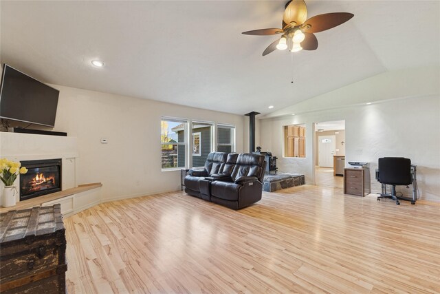 1020 3rd Ave E, Columbia Falls, MT 59912 - living area with ceiling fan, a glass covered fireplace, recessed lighting, wood finished floors, and lofted ceiling
