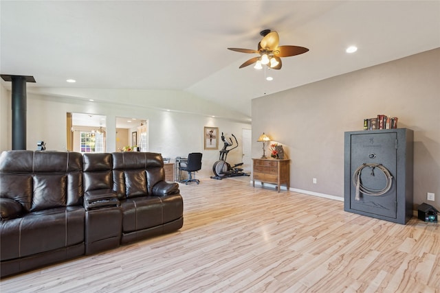 1020 3rd Ave E, Columbia Falls, MT 59912 - living room with ceiling fan, a wood stove, baseboards, light wood-type flooring, and vaulted ceiling
