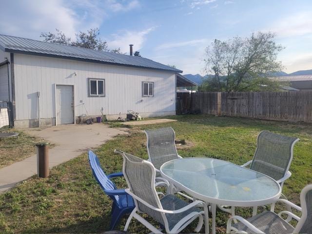 2421 Clark St, Victor, MT 59875 - rear view of property with a patio, metal roof, and outdoor dining space