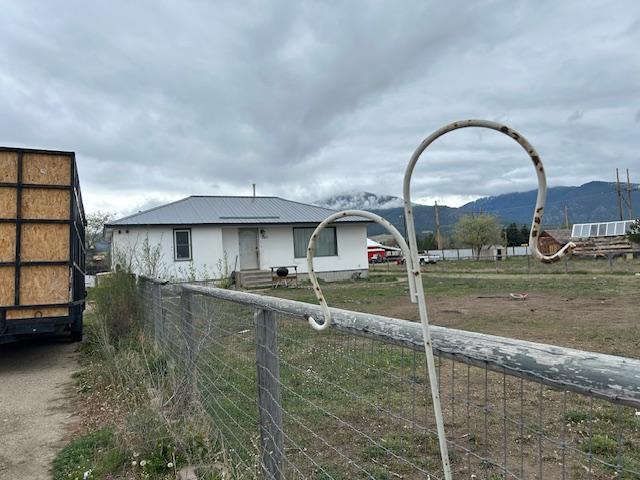 2421 Clark St, Victor, MT 59875 - view of front of property featuring a mountain view and metal roof