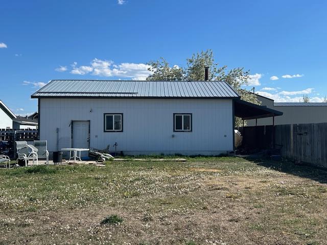 rear view of house featuring metal roof
