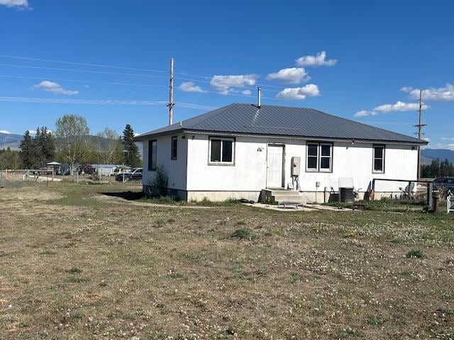 rear view of property with metal roof