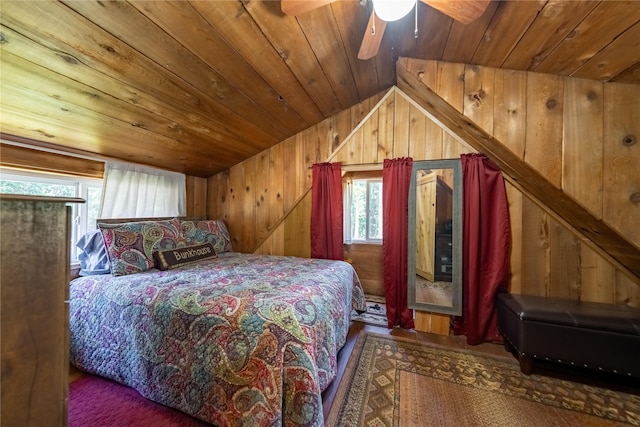 bedroom with wooden walls, wooden ceiling, ceiling fan, and vaulted ceiling