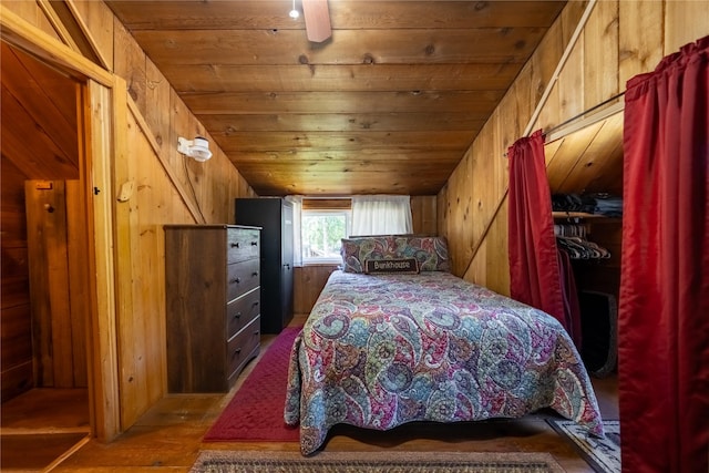 bedroom featuring wood walls, wood ceiling, and wood finished floors