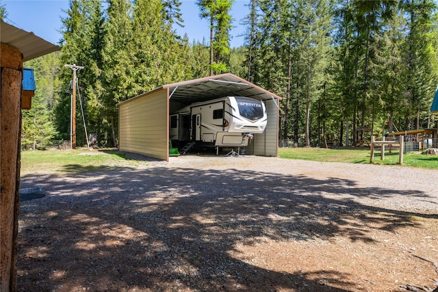 view of parking / parking lot featuring a carport and driveway