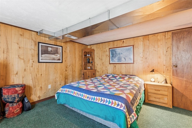 carpeted bedroom featuring visible vents and wooden walls