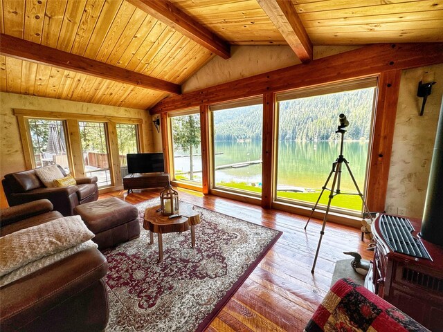 living room featuring hardwood / wood-style flooring and vaulted ceiling with beams