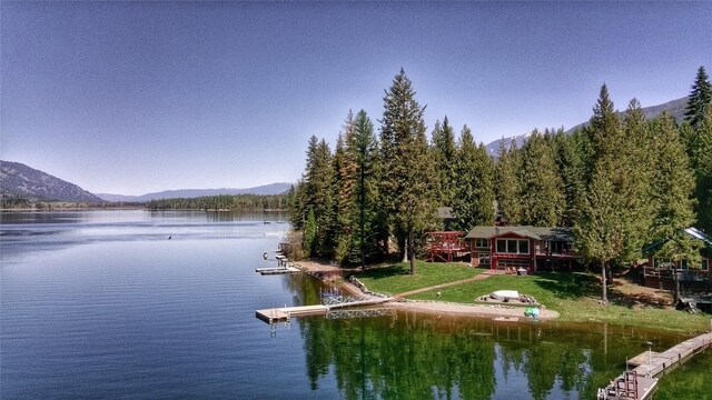 dock area featuring a yard and a deck with water view