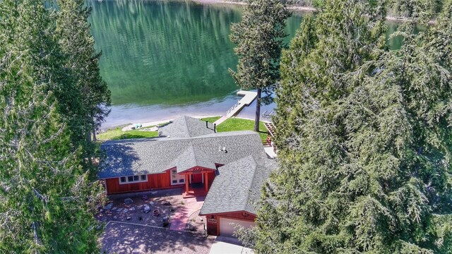 dock area featuring a deck with water view and a lawn