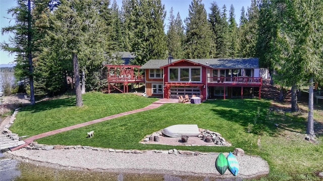 back of house featuring a yard, stairway, and a wooden deck