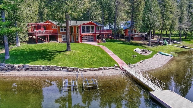 dock area featuring a deck with water view and a lawn