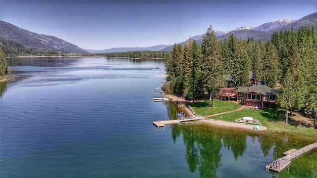 property view of water featuring a boat dock and a mountain view