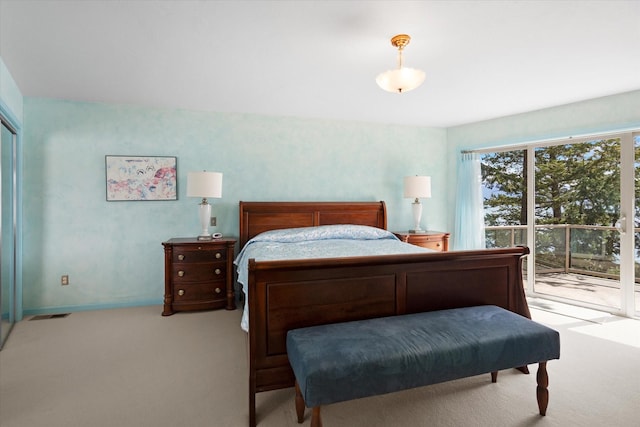 bedroom featuring light carpet, baseboards, and access to exterior