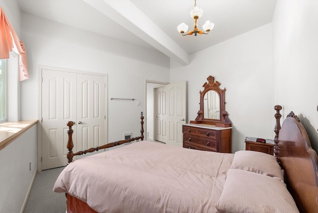 bedroom with an inviting chandelier, carpet flooring, a closet, and baseboards