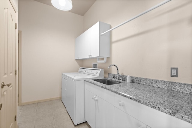 laundry area featuring baseboards, hookup for a washing machine, light tile patterned flooring, a sink, and cabinet space