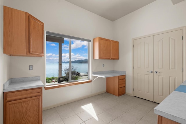 kitchen featuring baseboards, light countertops, and plenty of natural light