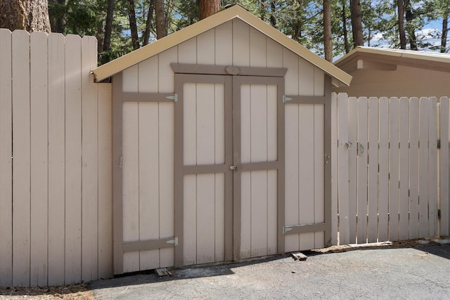 view of shed featuring fence