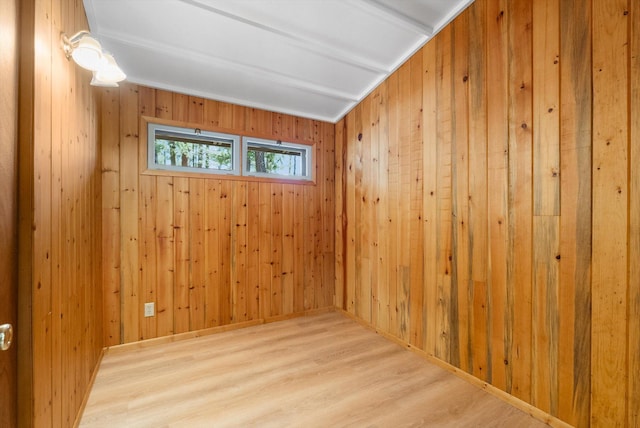 empty room with wood walls and wood finished floors