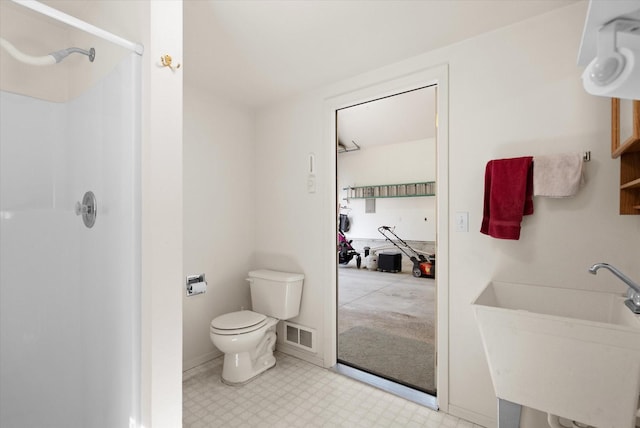 bathroom featuring a shower stall, visible vents, toilet, and a sink