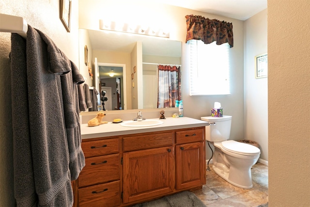 bathroom with toilet, curtained shower, and vanity
