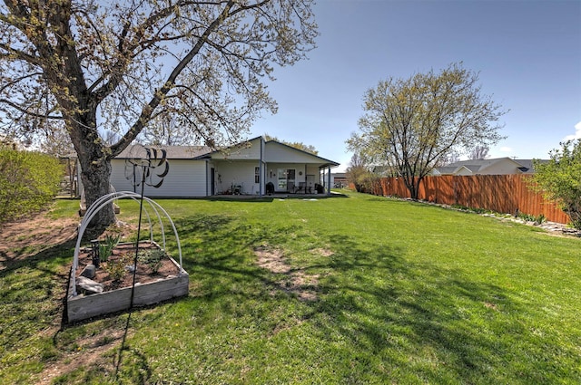 view of yard featuring a garden and fence
