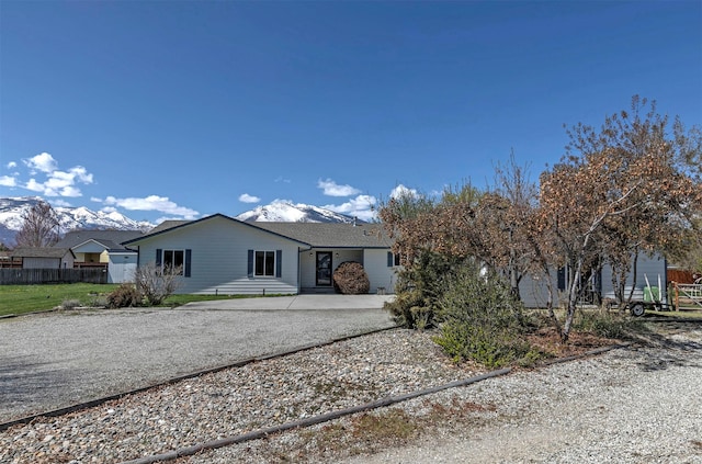 view of front facade featuring driveway and fence