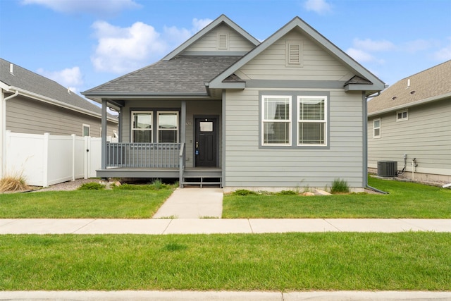 2421 Half Hitch Dr, Missoula, MT 59808 - view of front of house with covered porch, fence, a shingled roof, and a front yard