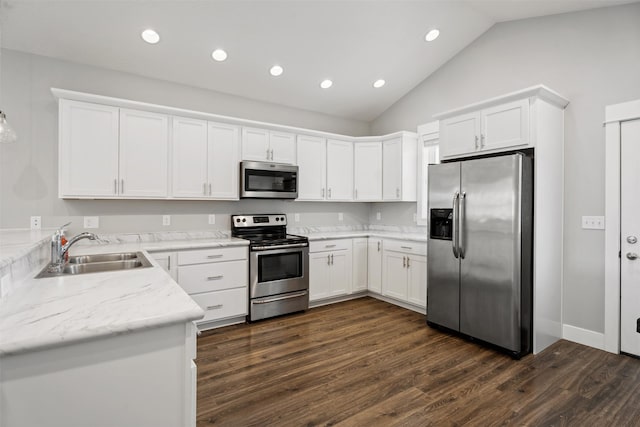 2421 Half Hitch Dr, Missoula, MT 59808 - kitchen with lofted ceiling, dark wood finished floors, a sink, stainless steel appliances, and white cabinets