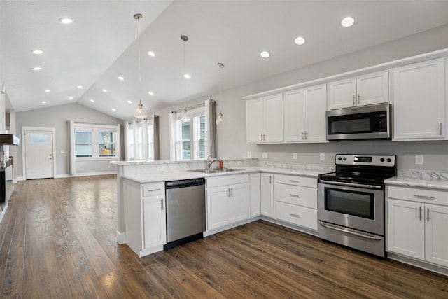 2421 Half Hitch Dr, Missoula, MT 59808 - kitchen with dark wood-style floors, a peninsula, appliances with stainless steel finishes, and a sink